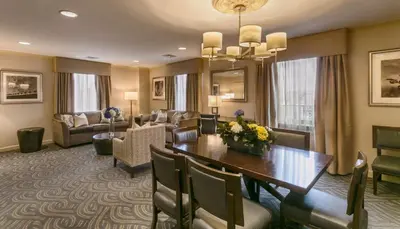 a dining room with a table and a living room at Robert Treat Hotel in Newark