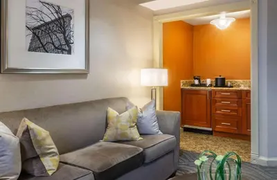 a living room with a couch in a hotel room at Robert Treat Hotel in Newark