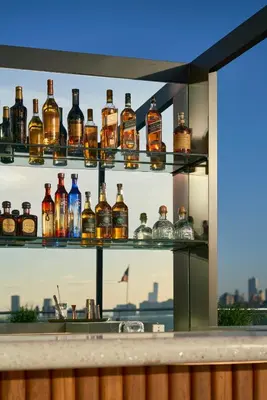a display of bottles of whiskey on a shelf at ModernHaus SoHo in New York