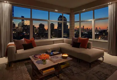 a living room with a couch and a large window at ModernHaus SoHo in New York