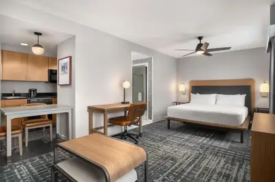 a hotel room with a bed and a kitchen at Homewood Suites by Hilton Newtown - Langhorne, PA in Newtown