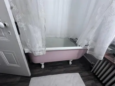 a bath tub in a bathroom with a curtain at Susquehanna Manor Inn in Marietta