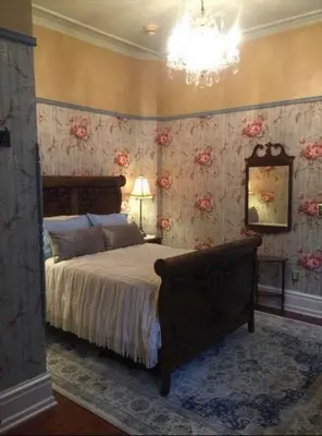 a bedroom with a bed with floral wallpaper at Susquehanna Manor Inn in Marietta