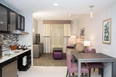 a living room with a kitchen and a living room with a table at Homewood Suites By Hilton Allentown Bethlehem Center Valley in Center Valley