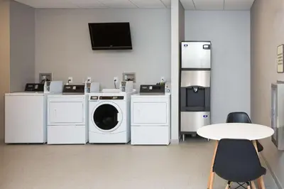 a laundry room with washing machines and a table at Homewood Suites By Hilton Allentown Bethlehem Center Valley in Center Valley