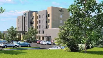 a parking lot with cars parked in front of a building at Homewood Suites By Hilton Allentown Bethlehem Center Valley in Center Valley