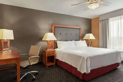 a hotel room with a bed and a desk and a bed sidx sidx at Homewood Suites by Hilton Allentown-West/Fogelsville in Fogelsville