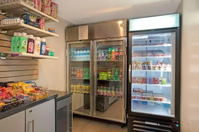 a large refrigerator with its doors open in a kitchen at Ramada by Wyndham Staten Island in Staten Island