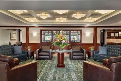 a waiting room with chairs and a table with flowers at Homewood Suites by Hilton Wilmington-Brandywine Valley in Talleyville