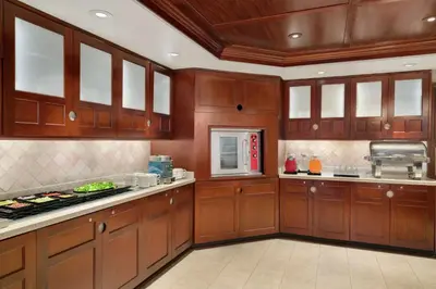 a large kitchen with wooden cabinets and appliances at Homewood Suites by Hilton Wilmington-Brandywine Valley in Talleyville
