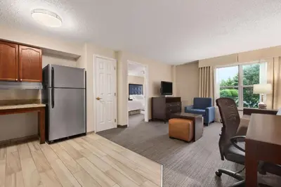 a kitchen and a living room with a refrigerator at Homewood Suites by Hilton Wilmington-Brandywine Valley in Talleyville