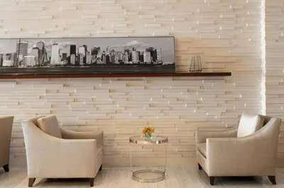 a living room with two chairs and a table at Sheraton Tribeca New York Hotel in New York