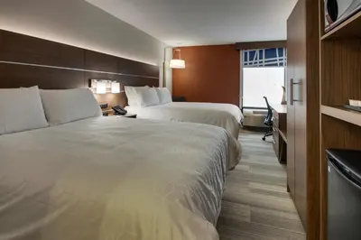 a hotel room with two beds and a window at Holiday Inn Express Voorhees/ Mt. Laurel by IHG in Voorhees