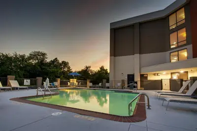 a swimming pool in front of a building at Holiday Inn Express Voorhees/ Mt. Laurel by IHG in Voorhees
