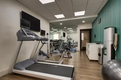 a gym with tread machines and a treadmill at Holiday Inn Express Voorhees/ Mt. Laurel by IHG in Voorhees