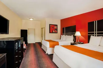 a hotel room with two beds and red walls at Howard Johnson by Wyndham North Plainfield in North Plainfield