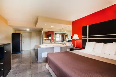 a hotel room with a bed and a bath tub at Howard Johnson by Wyndham North Plainfield in North Plainfield