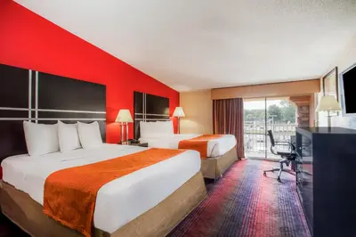 a hotel room with two beds and a flat screen tv at Howard Johnson by Wyndham North Plainfield in North Plainfield