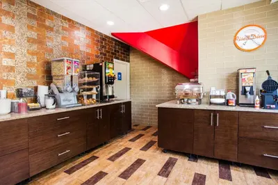 a restaurant kitchen with wooden cabinets and a red ceiling at Howard Johnson by Wyndham North Plainfield in North Plainfield