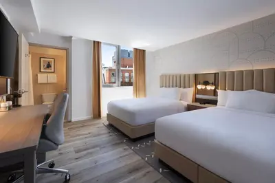 a hotel room with two beds and a desk at Courtyard by Marriott New York Manhattan / Soho in New York