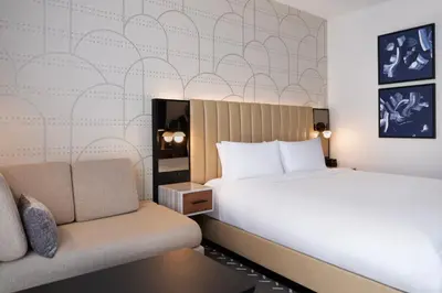 a hotel room with a bed and a couch at Courtyard by Marriott New York Manhattan / Soho in New York