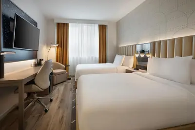 a hotel room with two beds and a desk at Courtyard by Marriott New York Manhattan / Soho in New York