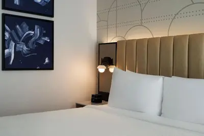 a bedroom with a large bed with a white bedspread at Courtyard by Marriott New York Manhattan / Soho in New York