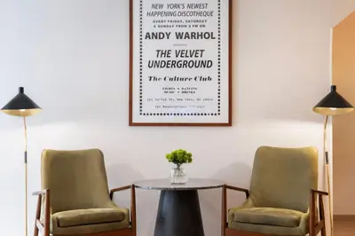two chairs and a table in a room with a picture on the wall at Courtyard by Marriott New York Manhattan / Soho in New York