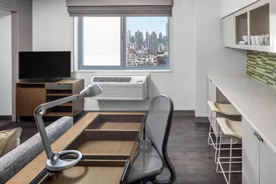 an office with a chair and a desk with a window at Element Times Square West in New York