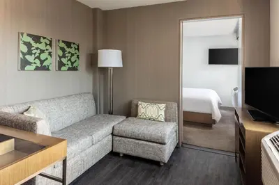 a living room with a couch and a bedroom at Element Times Square West in New York