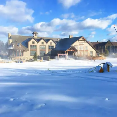 a large building with snow in front of it at The Appalachian at Mountain Creek in Vernon
