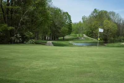 a golf course with a pond and a golf green at The Appalachian at Mountain Creek in Vernon