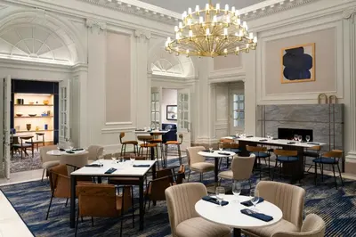 a restaurant with tables and chairs and a chandelier at Courtyard by Marriott Philadelphia Downtown in Philadelphia