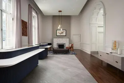 a living room with a fireplace and a table and a chair at Courtyard by Marriott Philadelphia Downtown in Philadelphia