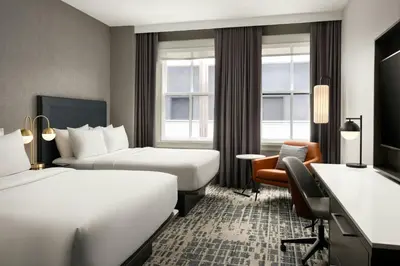 a hotel room with two beds and a desk at Courtyard by Marriott Philadelphia Downtown in Philadelphia