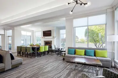 a living room with a couch and a table at Hilton Garden Inn Allentown West in Breinigsville