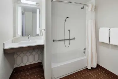 a bathroom with a shower and a sink at Hilton Garden Inn Allentown West in Breinigsville
