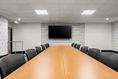 a conference room with a wooden table and chairs at Hampton Inn Bordentown in Bordentown