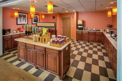 a restaurant with a counter in the middle of a room at Hampton Inn & Suites Binghamton/Vestal in Vestal