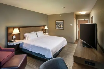 a hotel room with a bed and a flat screen tv at Hampton Inn & Suites Binghamton/Vestal in Vestal