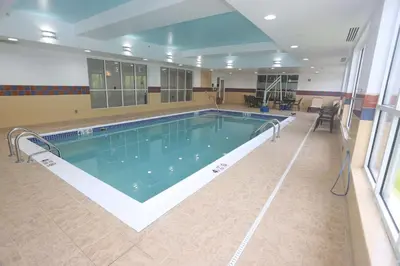 a large swimming pool in a building at Hampton Inn Owego in Owego