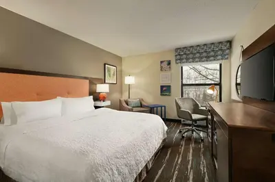 a hotel room with a bed and a flat screen tv at Hampton Inn Binghamton/Johnson City in Binghamton