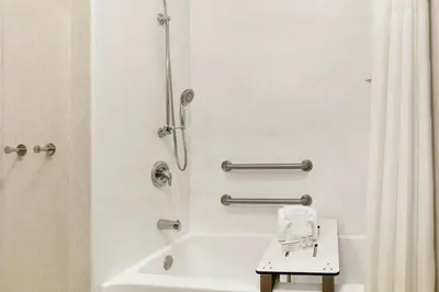 a white bathroom with a tub and a shower at Hampton Inn Binghamton/Johnson City in Binghamton