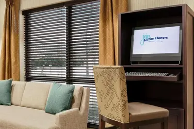 a living room with a couch and a television at Hampton Inn Binghamton/Johnson City in Binghamton