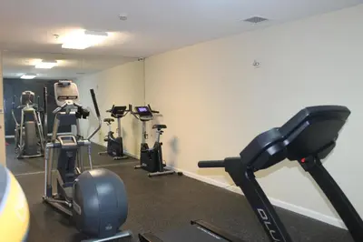a gym with several tread machines in a room at Days Inn by Wyndham Budd Lake in Budd Lake