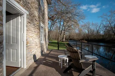 a pair of chairs on a porch with a door at Allenberry Resort in Carlisle