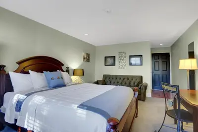 a bedroom with a large bed and a desk and a couch at Allenberry Resort in Carlisle