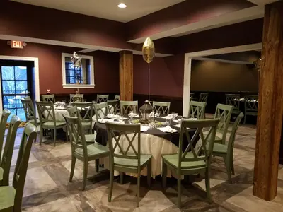 a dining room with a long table and chairs at Allenberry Resort in Carlisle