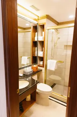 a bathroom with a toilet and a sink and a shower at The Allen Hotel in New York