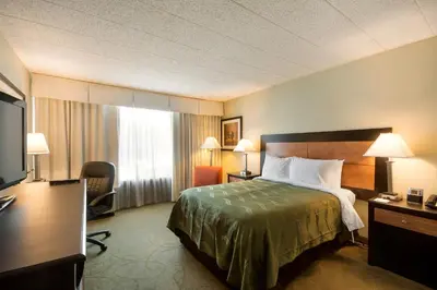 a hotel room with a bed and a television at Chester Hotel and Conference Center in Exton